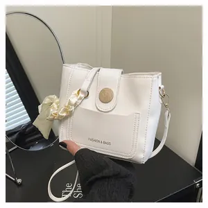 White leather bucket bag with silk scarf detail and Fashion & Bags text inscription