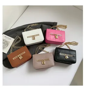 Flat lay of chain crossbody bags in five colors with faux crocodile texture and gold locks