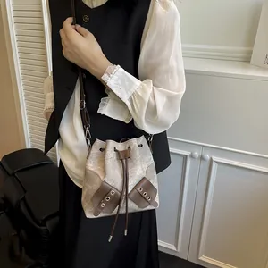 Vintage colorblock bucket bag in beige canvas and brown leather with shoulder strap