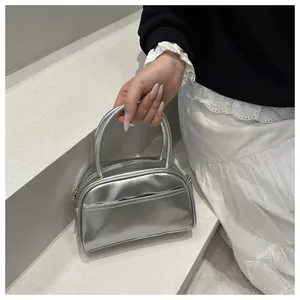 Silver metallic mini tote bag with dual handles and stylish mirror finish texture