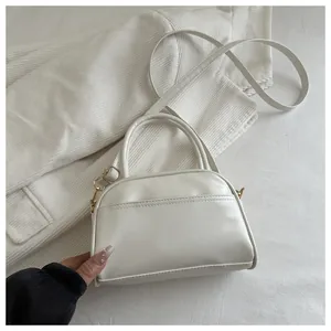 Minimalist white tote bag detail on corduroy fabric with golden zipper and top handle