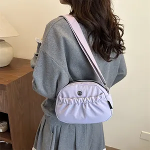 Minimalist purple nylon crossbody bag for women with ruched pocket and broad strap