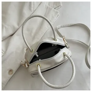 Top-down view of open beige leather mini square bag showing interior phone capacity