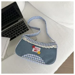 Detail of denim and blue plaid patchwork handbag with lace trim and cherry patch