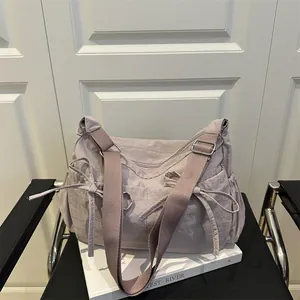Chic light purple nylon hobo bag with side bow accents and adjustable wide strap