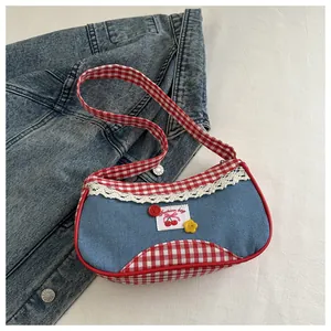 Detail view of retro denim shoulder bag with red plaid trim and delicate lace edge decoration