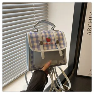 Detail of blue plaid multi-functional small bag with red apple pattern and metal buckle