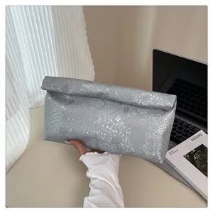 Detail showing snake pattern texture and roll-top design on silver-grey clutch bag