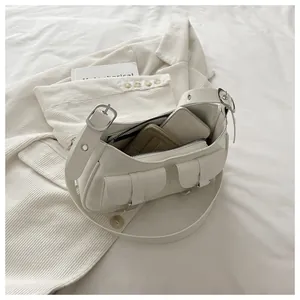 Detail view of cream leather tote bag interior showing capacity for phone and card holder