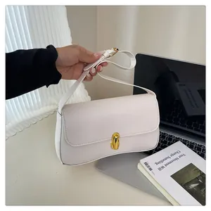 Detail of white rectangle shoulder bag with elegant gold twist lock and wide strap