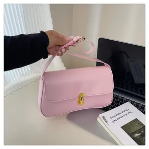 Detail of light pink shoulder bag with gold twist lock and smooth leather texture