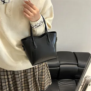 Minimalist black leather bucket bag with fashion print and dual handles for women
