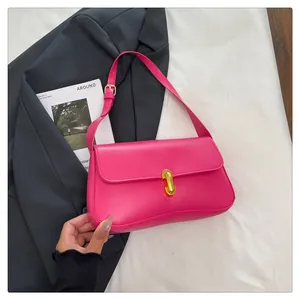 Detail of fuchsia square bag with gold twist lock on minimalist magazine background