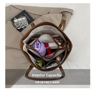 Macro view of the large internal capacity with zipper compartment in brown tote bag