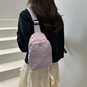 Minimalist lavender nylon chest bag with adjustable strap and front zipper pocket