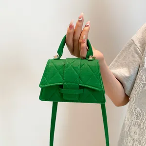 Bright green quilted micro tote bag with gold hardware and suede texture for women