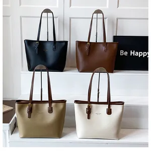 Tote bags in black, brown, khaki, and cream colors displayed on steps for women