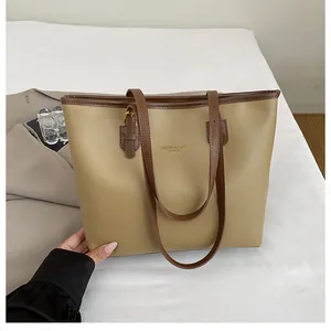 Detail of khaki tote bag with dark brown straps and gold Xiaoer Bags Fashion logo