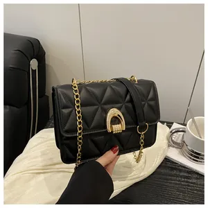 Détail du sac à bandoulière matelassé noir avec fermoir fer à cheval doré et chaîne