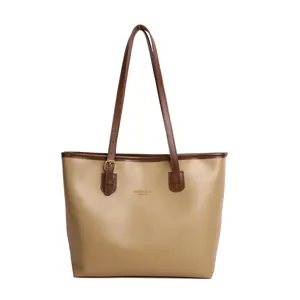 Elegant two-tone tote bag in khaki and dark brown leather with minimalist gold branding
