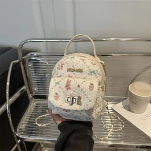 Mini cream backpack with cartoon patterns, gold hardware and metal chain strap for women