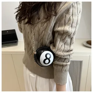 Detail of creative 8-ball billiards shaped crossbody bag with gold chain strap for women