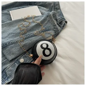 Detailed view of creative black billiards 8-ball crossbody bag with gold chain strap