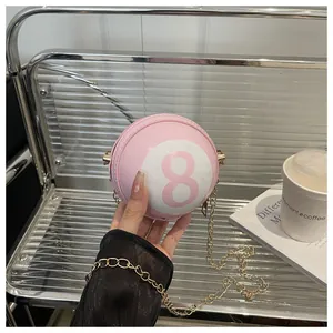 Detailed view of pink billiard-shaped spherical bag with chain strap and number 8 print