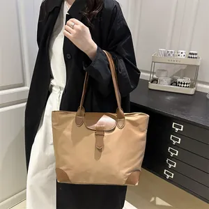 Minimalist khaki and brown leather tote bag for women shown with model in office setting