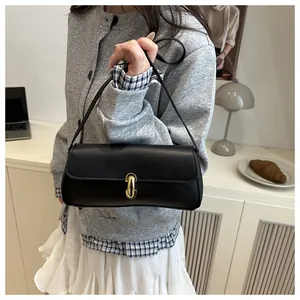 Fashionable black pebbled leather handbag featuring a chic gold metal lock and twist buckle