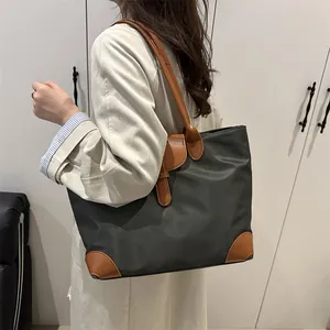 Deep grey and brown leather tote bag with a spacious minimalist British retro design