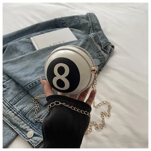 Detail of creative Billiard Black 8 round chain bag with gold hardware and white PU leather