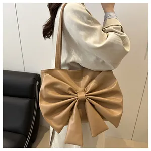 Dettaglio del grande fiocco decorativo e della trama a pieghe sulla borsa tote kaki