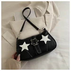 Detail of lychee pattern leather bag with white star patches and silver star buckle
