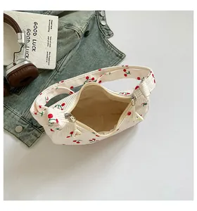 Detail view of corduroy cherry print dumpling bag interior with dual zippers