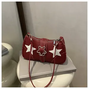Close-up of red underarm bag with white star patches and silver star metal buckle