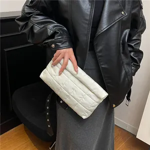 Minimalist white quilted puffer clutch bag with square stitching and flap design