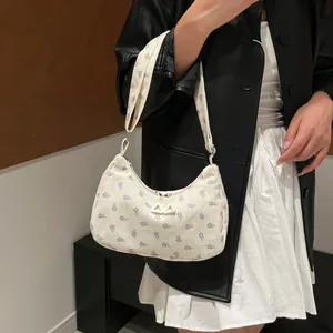 Floral corduroy dumpling shoulder bag with purple prints and triangle charms