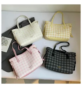 Flat lay of four checkered tote bags in beige, yellow, pink, and black with brand logo