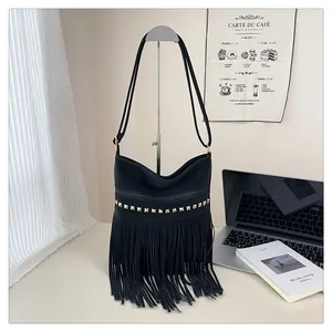 Détail du sac à franges noir avec rivets dorés et fermeture éclair élégante