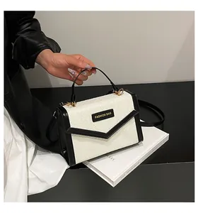 Detail of a woven black and white handbag with Fashion Bag label and smooth strap