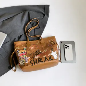 Detail view of large graffiti tote bag showing bear patterns and faux leather texture