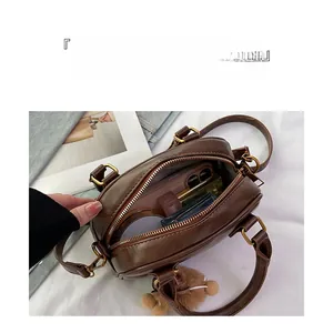 Detail view of brown vintage bag interior showing storage compartments and capacity