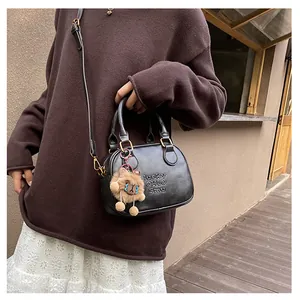 Detail of black leather square bag with lucky CHLO smu embossed text and lion pendant
