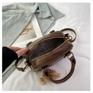 Top view of dark brown mini bag showing spacious interior with zipper pocket