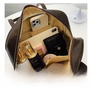 Detail view of the spacious inner compartment with functional pockets for daily essentials