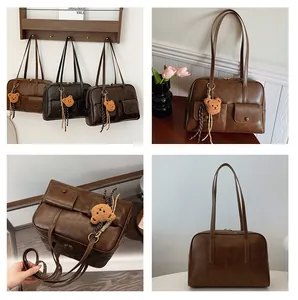 Detail view of vintage PU leather shoulder bags with multi-pocket design and plush bear charm