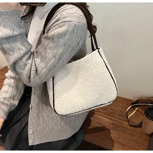Lambswool tote bag with brown leather trim shown in a cozy lifestyle setting