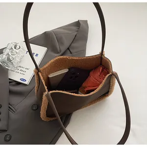Interior view of brown suede shoulder bag with plush trim showing large capacity for essentials