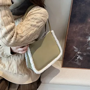 Olive green faux suede tote bag with white faux shearling trim and shoulder strap